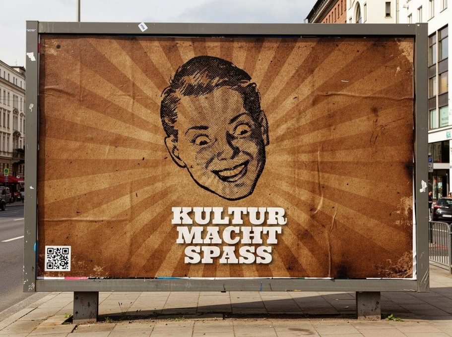 Plakat mit dem Text „KULTUR MACHT SPASS“ und einem lächelnden Gesicht.